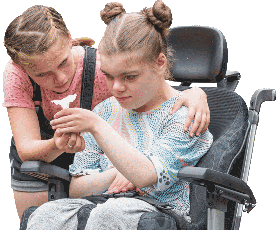 Sisters holding a flower with one sister in a wheelchair