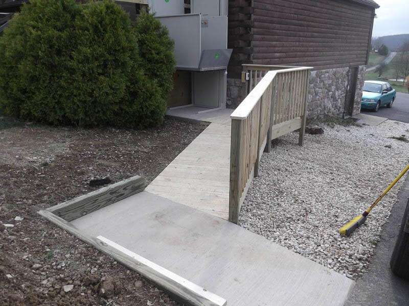 Central PA concrete and wood wheelchair ramp leading to outdoor platform ramp