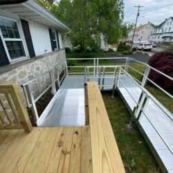 Metal wheelchair ramp connecting to wooden porch in Pennsylvania