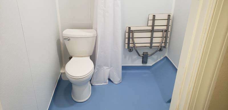 Wetroom with blue floor and fold away chair in central PA